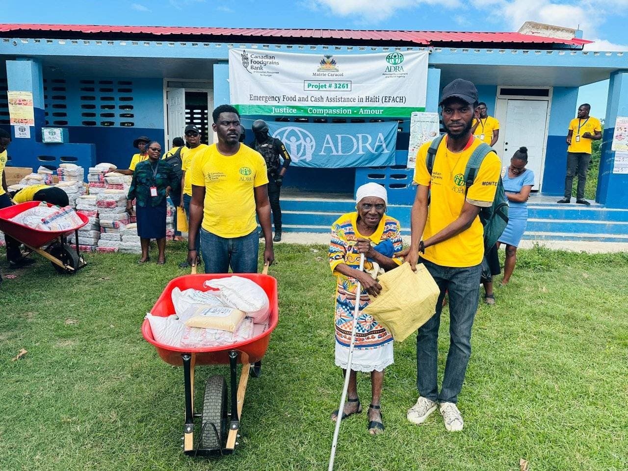 An elderly woman receives a food kit during ADRA Haiti’s EFACH distribution.